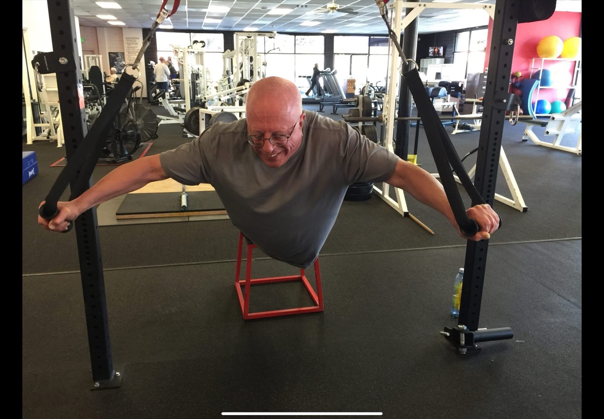 Client doing TRX chest fly at the gym